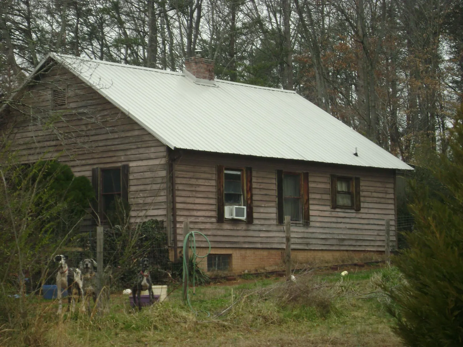 White metal roof on an old wood sided farmhouse, from a Metal Roof Installation job in Summerdale